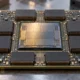 AI accelerator package with a central processor and surrounding memory stacks.