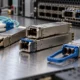 Optical transceiver modules and fiber connectors beside a network switch.